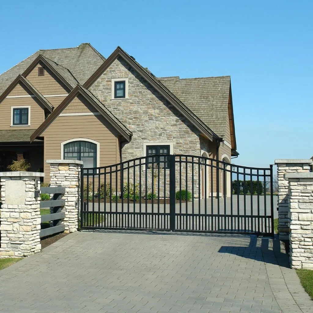 An automatic entry gate and stone columns installed by Discount Fence USA